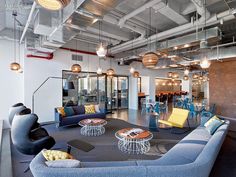 an office lobby with couches, tables and chairs