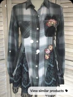 a mannequin wearing a plaid shirt with floral appliques