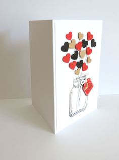 a card with hearts in a mason jar