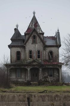 an old abandoned house with birds flying around