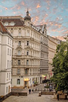 an old building with many windows and balconies on the top floor is shown at sunset