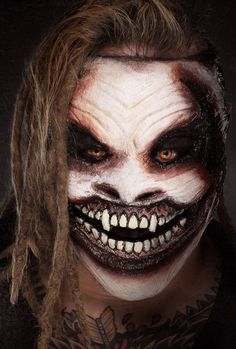 a man with long hair and makeup is dressed as a scary clown for the camera