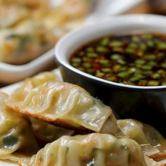 some food is sitting on a plate with a bowl of soup in the back ground