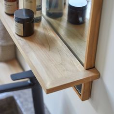 a shelf with some jars and candles on it