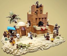 a lego model of a castle with people and animals