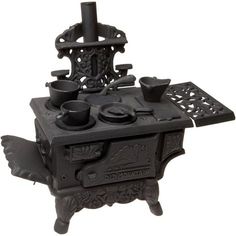 an antique cast iron stove with pots and pans on it's burners