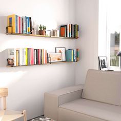 a living room filled with furniture and bookshelves next to a wall mounted book shelf