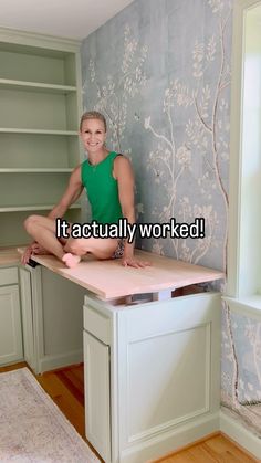 a woman sitting on top of a kitchen counter