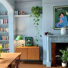 a living room filled with lots of furniture and bookshelves next to a fire place