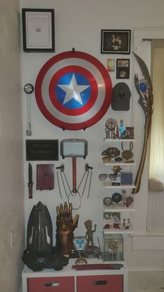 the captain's shield is hanging on the wall above some other items and memorabilia