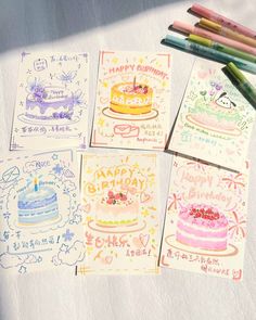 four birthday cards with colored pencils next to them