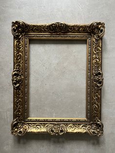 an ornate gold frame hanging on the wall