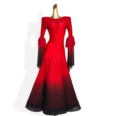 a red and black dress with long sleeves on a mannequin headdress