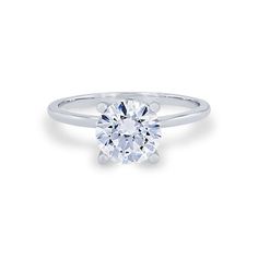 a white gold engagement ring with a round brilliant cut diamond on the top, set in 18k white gold