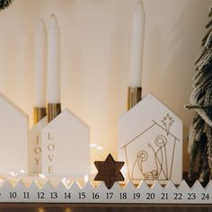 a christmas scene with candles and nativity items on the mantle in front of them