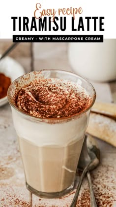 a close up of a drink in a glass with cinnamon sprinkles on top