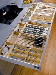 an open drawer with utensils in it