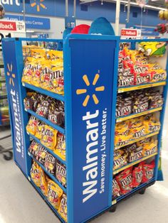 a walmart display in a grocery store filled with snacks and candy bar flavors for sale