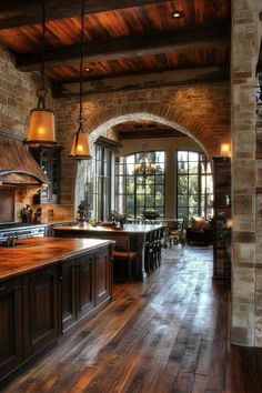 a large kitchen with wooden floors and stone walls