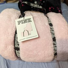 a pink teddy bear with black straps on it's back