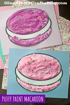 some pink frosted cake with sprinkles on it and the words puffy paint macaron