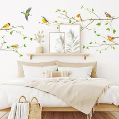 a bed sitting under a tree with birds on it's branches and green leaves