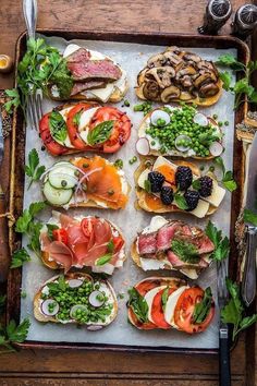 a tray filled with lots of different types of food on top of a wooden table