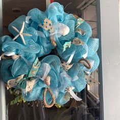 a blue wreath with starfish and seashells on it