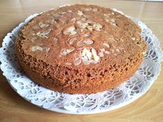 a cake on a doily sitting on top of a wooden table