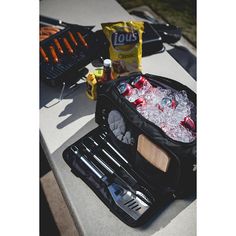 an open lunch bag sitting on top of a table next to a bottle of soda