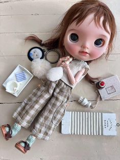 a doll laying on the floor next to other items