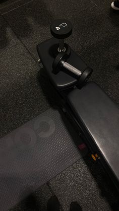 an exercise equipment sits on the floor in a gym