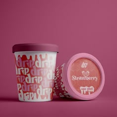 two cups with lids are sitting next to each other on a pink and red background