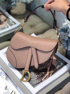 Description CHRSTN DR Saddle Bag Blush Grained For Women, Women’s Bags 19.5cm/7.6in CD Rep 1:1 Measurements: 19.5 x 16 x 6.5 cm / 7.6 x 6.2 x 2.5 in The iconic Saddle bag, crafted in white , is reimagined by Maria Grazia Chiuri. The legendary design is embellished with a Oblique perforations motif and features a Saddle flap with a magnetic ‘D’ stirrup clasp and an antique gold-finish metal ‘CD’ signature on either side of the strap. The bag has a wide embroidered strap, both adjustable and remov Christian Dior Saddle Bag, Louis Vuitton Shirt, Dior Oblique, Dior Saddle, Designer Accessories Fashion, Maria Grazia, Luxury Products, Loafer Mules, Saddle Bag