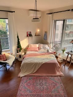 a bed room with a neatly made bed next to two windows and a rug on the floor