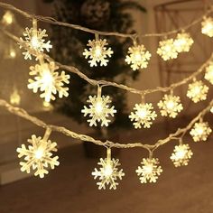 snowflake lights are hanging from a string