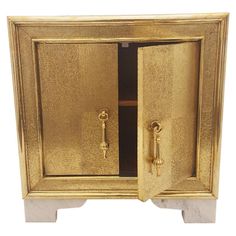 a golden cabinet with two doors and handles