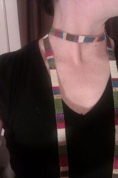 a woman wearing a multicolored striped necklace