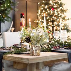 a christmas table setting with candles and decorations