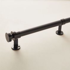 a black metal rail on a white surface