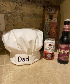 two bottles and a hat sitting on a counter