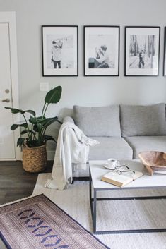 a living room filled with furniture and pictures on the wall