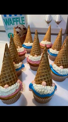 some cupcakes with cones on top of them