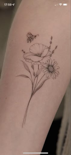 a tattoo with flowers on the arm