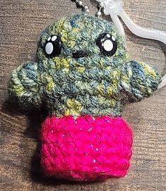 a crocheted key chain with a stuffed animal on it