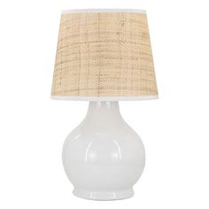 a white table lamp with a beige shade