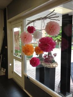 some flowers are hanging from a window