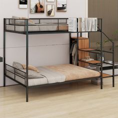 a bunk bed sitting in the middle of a room next to a desk and bookshelf