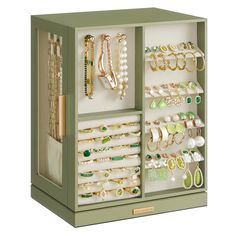 a green jewelry box filled with lots of different types of bracelets and necklaces