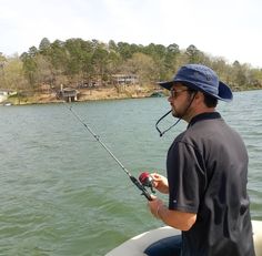 a man on a boat holding a fishing rod